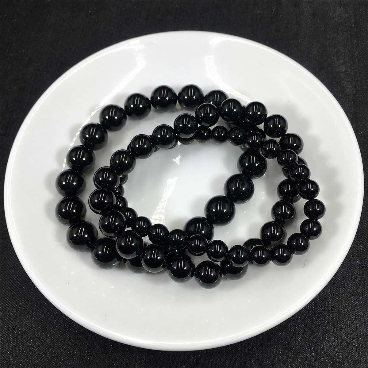 Black tourmaline bracelets showing bead sizes and polished surfaces