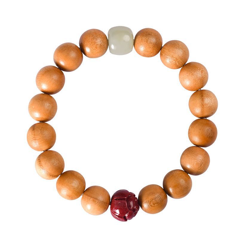 Overhead view of the original peach wood lotus bracelet on white