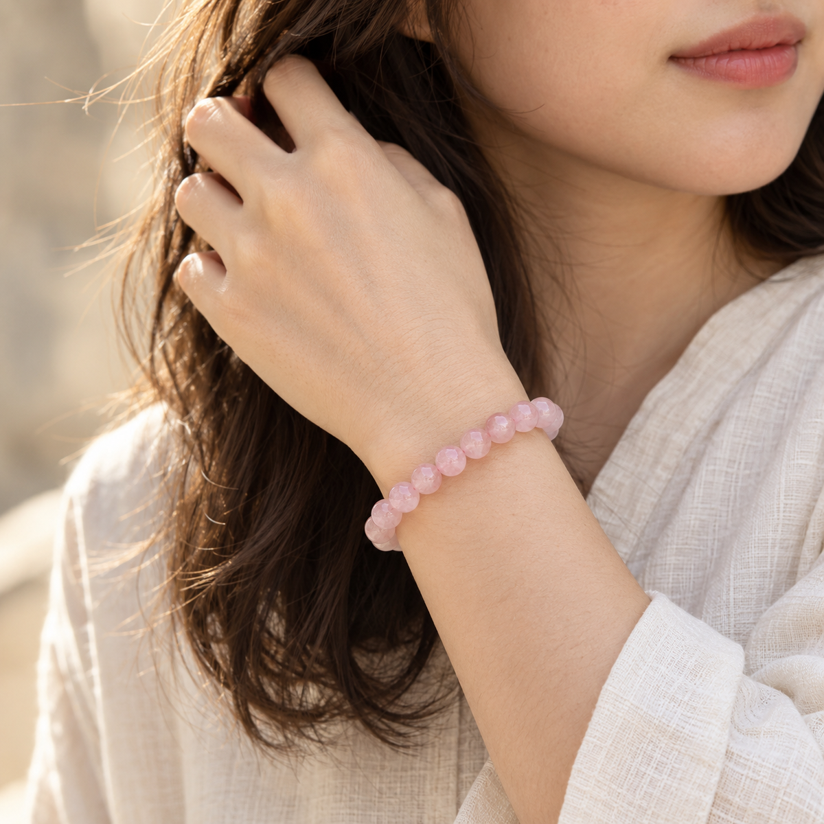 Natural Rose Quartz Bracelet – elegant lifestyle wrist view with cream linen outfit