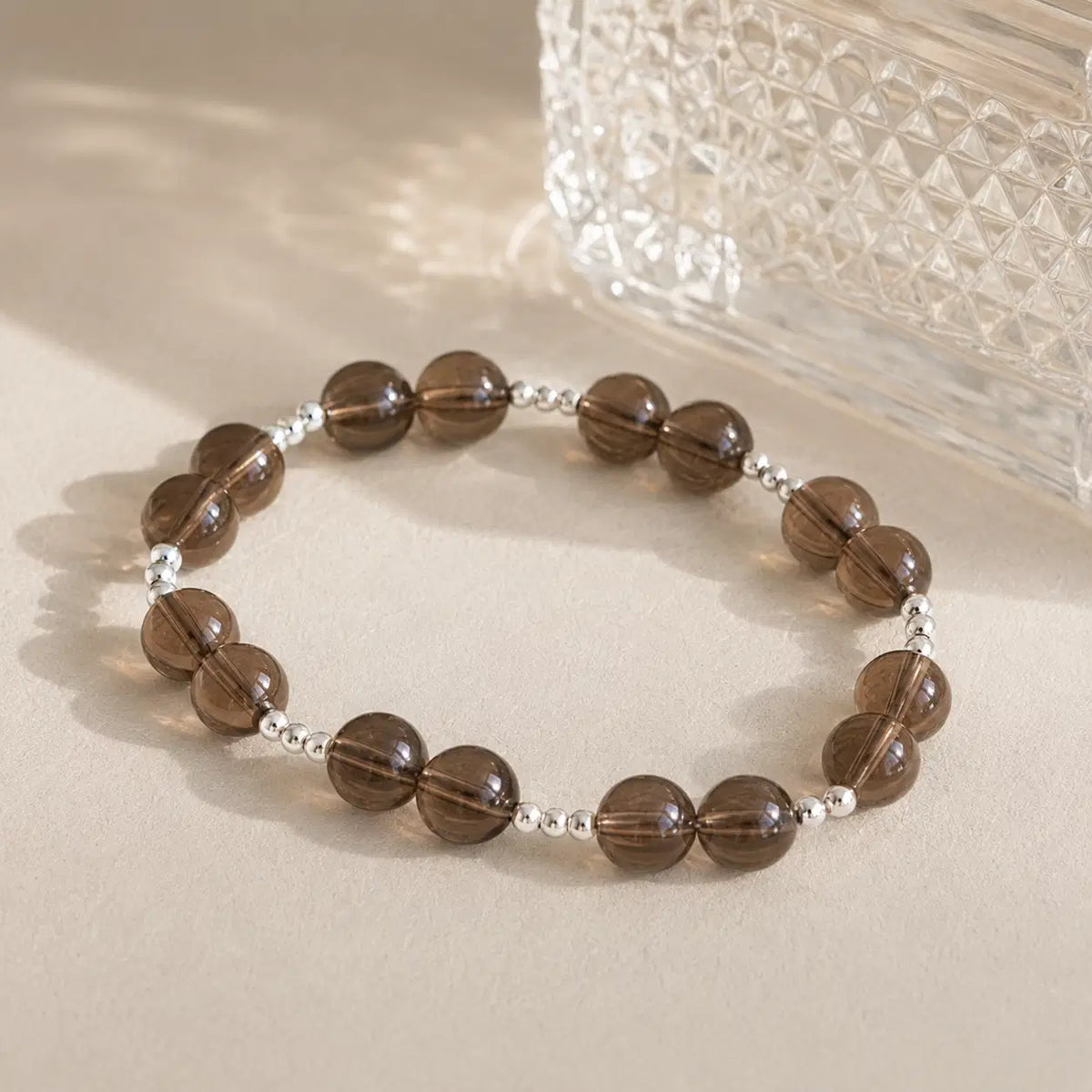 7A Natural Smoky Quartz Bracelet – 8mm – diagonal glass-bottle still life