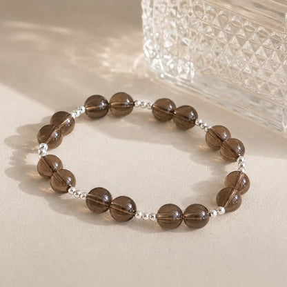 7A Natural Smoky Quartz Bracelet – 8mm – diagonal glass-bottle still life