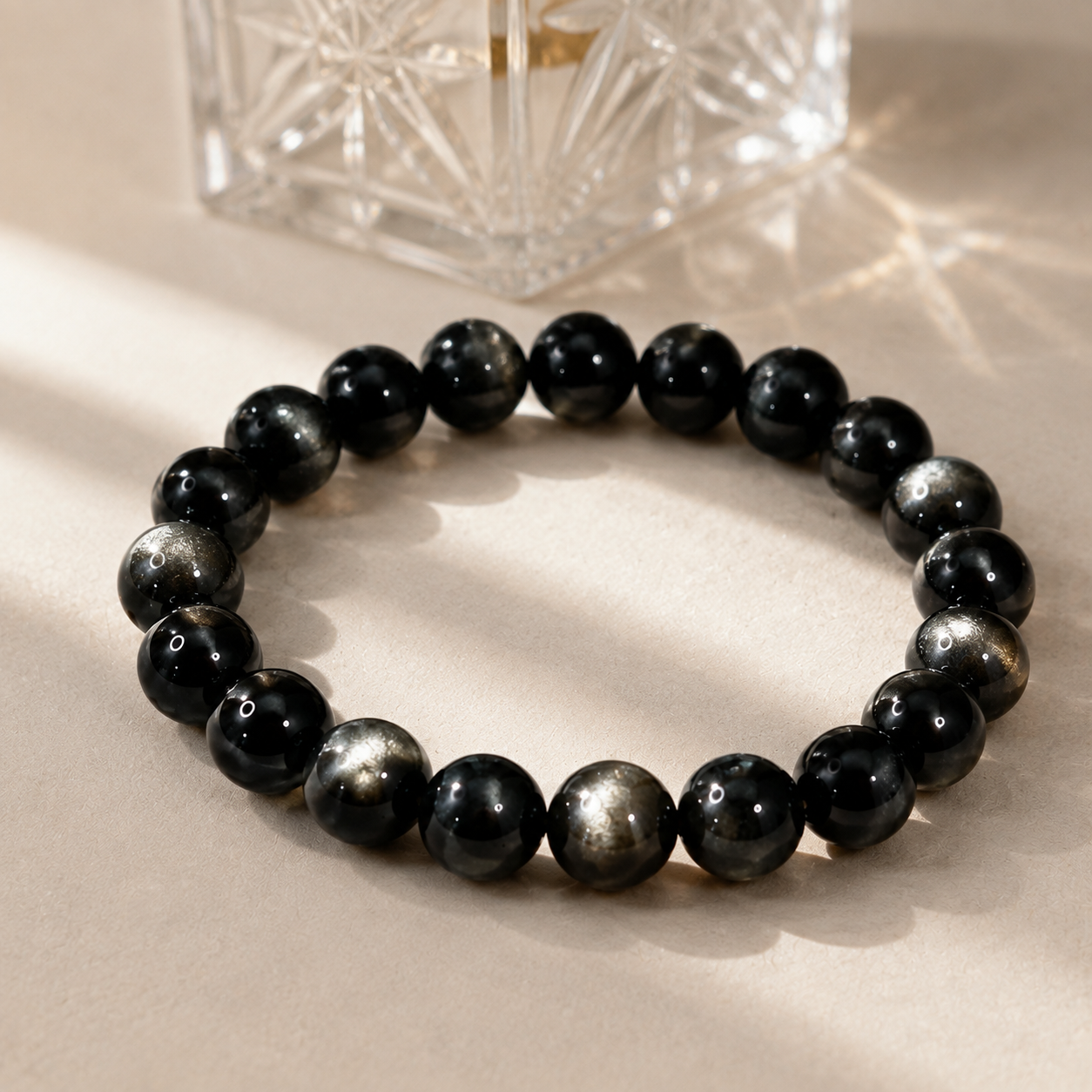 7A Silver Sheen Obsidian Bracelet – 8mm – diagonal glass-bottle still life