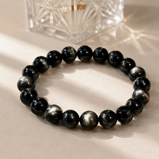 7A Silver Sheen Obsidian Bracelet – 8mm – diagonal glass-bottle still life