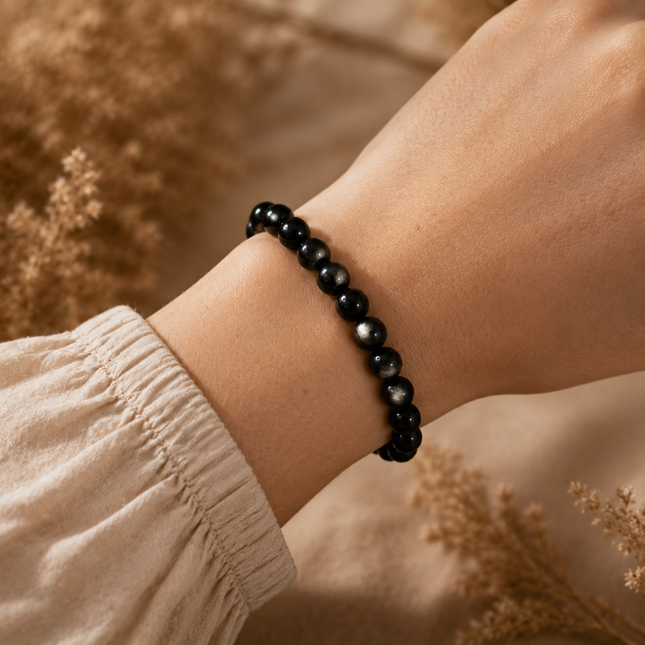 7A Silver Sheen Obsidian Bracelet – 8mm – realistic on-wrist view