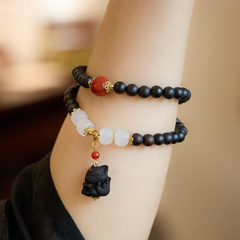 Agarwood fox charm bracelet worn in two wraps on the wrist