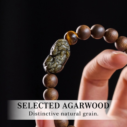 Close-up of carved Pixiu and agarwood bead texture