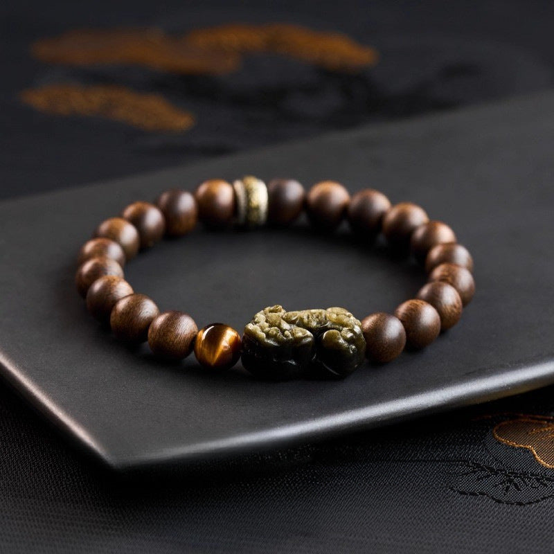 Complete agarwood Pixiu bracelet on dark tray