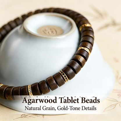 Close view of agarwood grain and gold-tone spacers