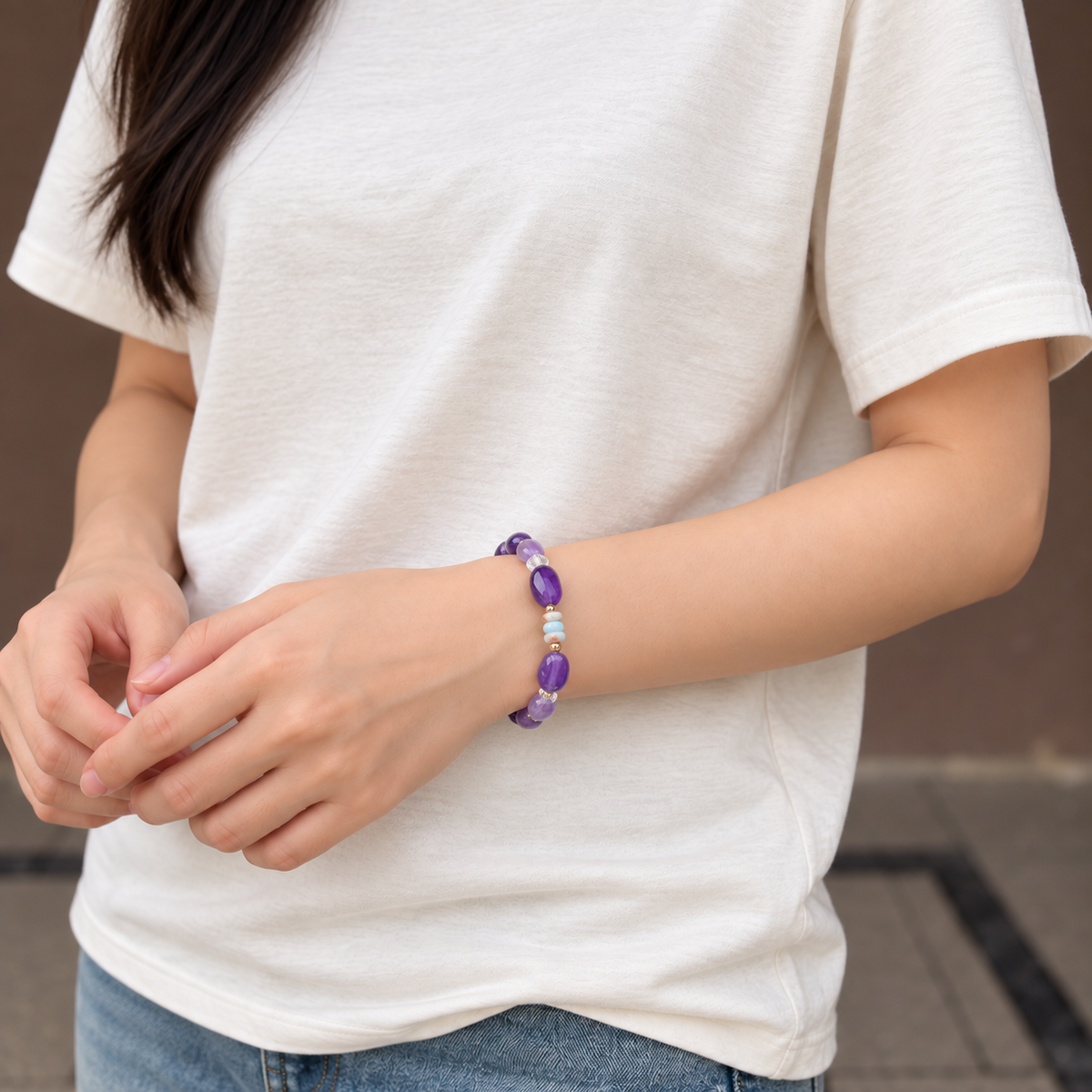 Amethyst and Shoushan bracelet worn with a white T-shirt, front wrist view
