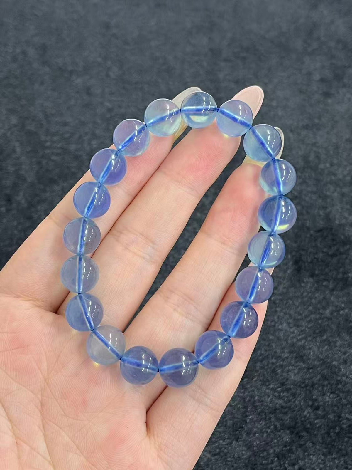 Aquamarine bracelet showing bead translucence and blue cord