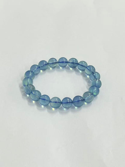 Aquamarine bracelet showing bead translucence and blue cord