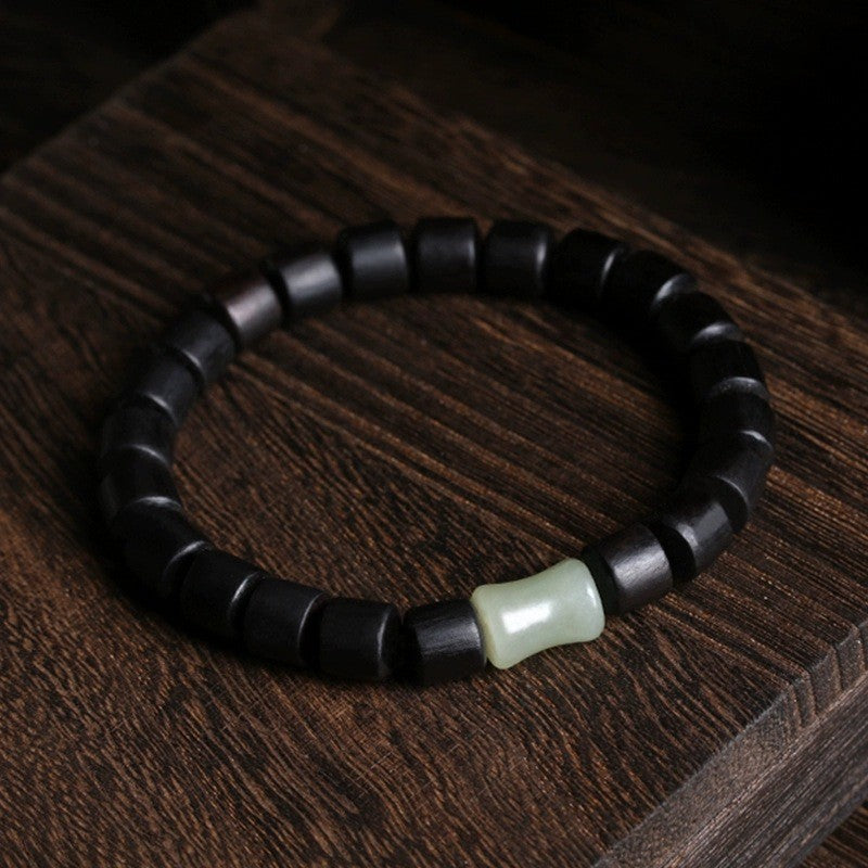 Ebony barrel bead bracelet with pale green jade accent