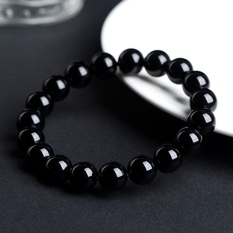 Angled view of polished black obsidian beads