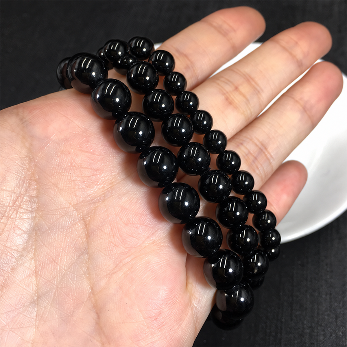 Black tourmaline bracelets showing bead sizes and polished surfaces
