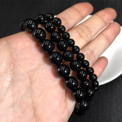 Black tourmaline bracelets showing bead sizes and polished surfaces