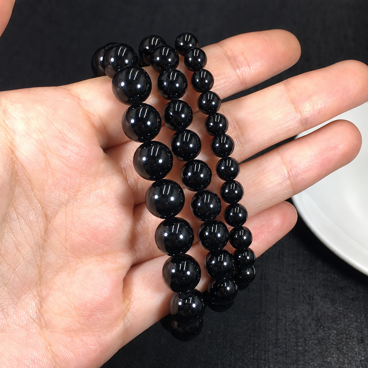 Black tourmaline bracelets showing bead sizes and polished surfaces