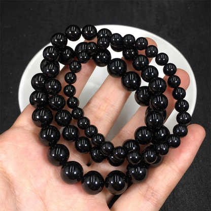 Black tourmaline bracelets showing bead sizes and polished surfaces
