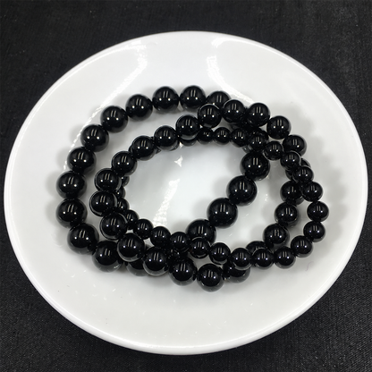 Black tourmaline bracelets showing bead sizes and polished surfaces
