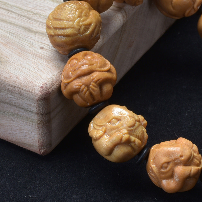 Sandalwood zodiac bracelet – carved animal relief close-up