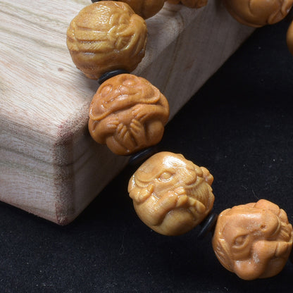 Sandalwood zodiac bracelet – carved animal relief close-up