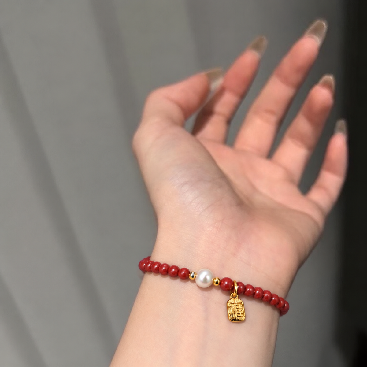 4mm Cinnabar-Style & Freshwater Pearl Bracelet worn on wrist