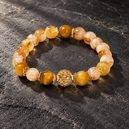 Citrine and tiger eye bracelet displayed on dark stone