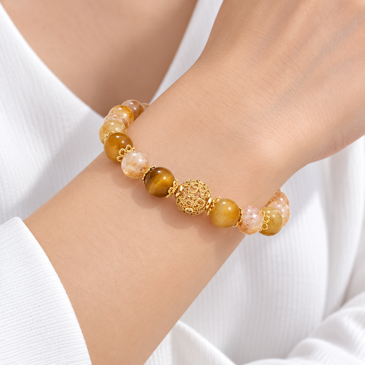 Close wrist view of citrine and tiger eye bracelet