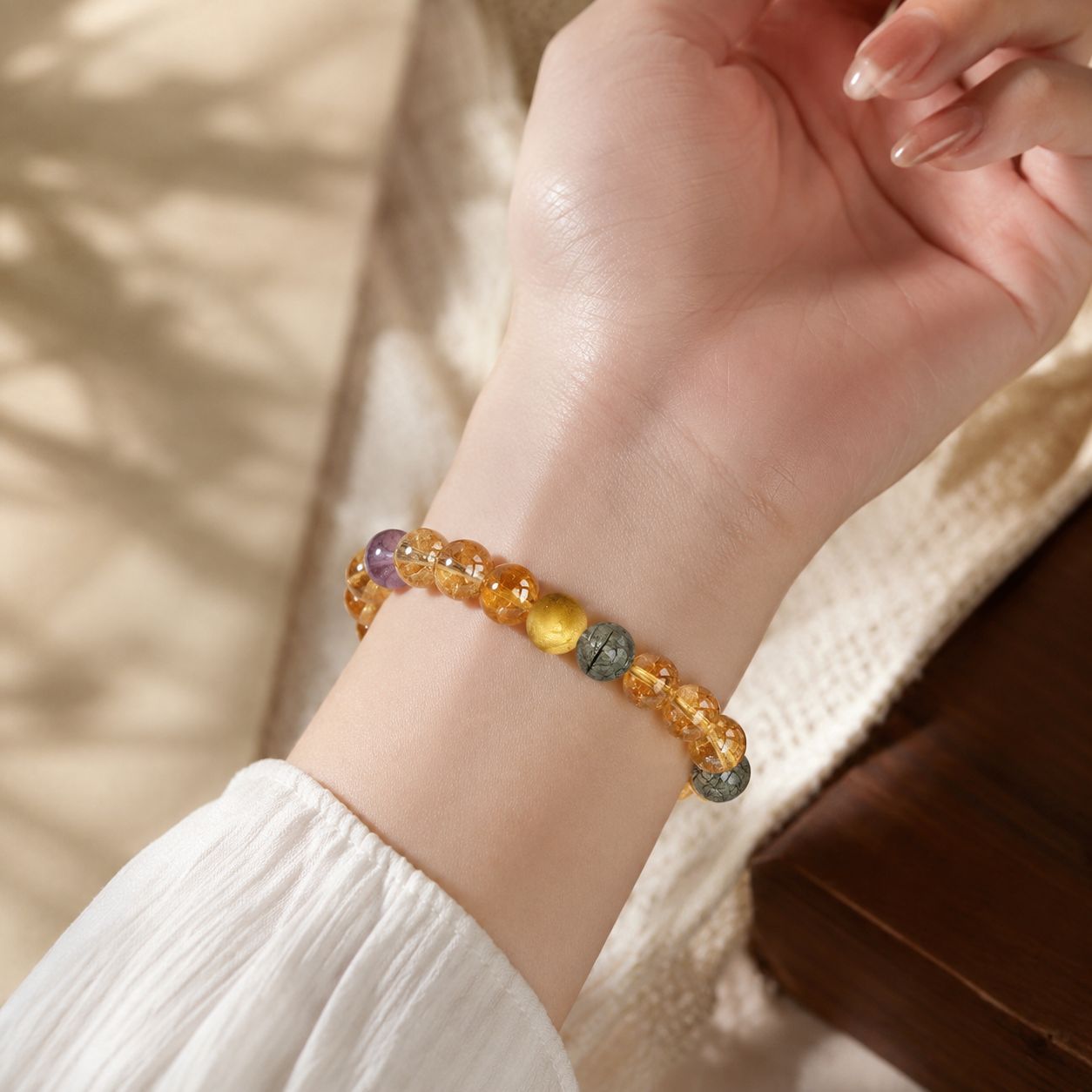 Natural citrine and rutilated quartz bracelet worn on wrist