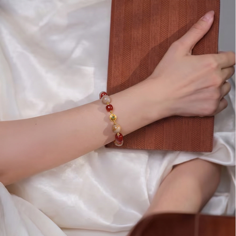 Cherry red mixed bead bracelet worn on the wrist