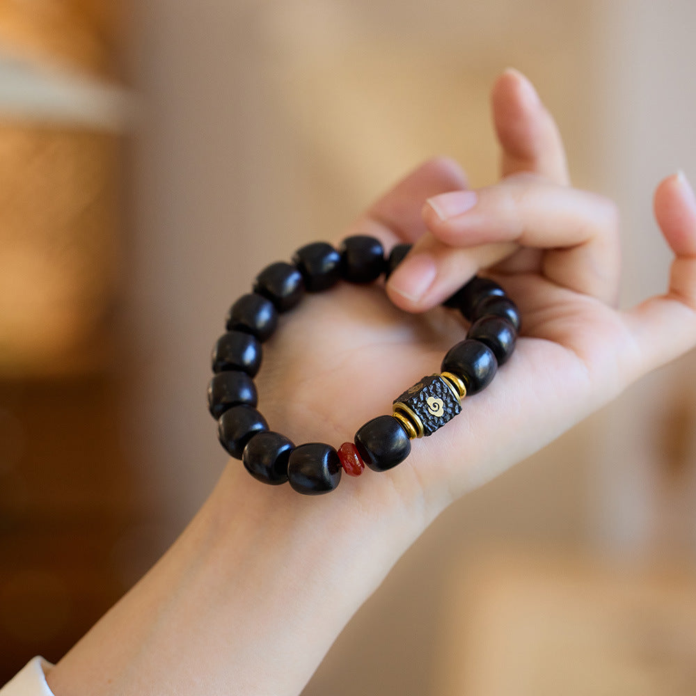 Ebony bracelet held to show the complete strand
