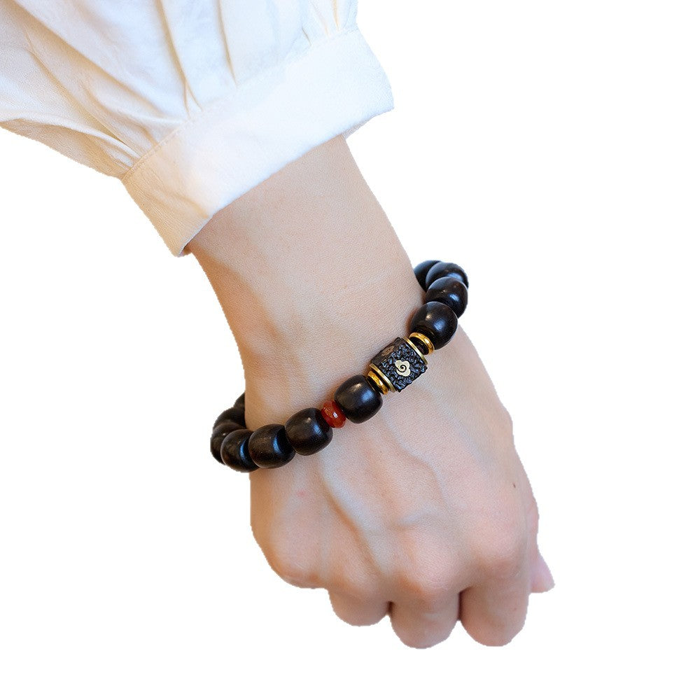 11mm ebony barrel bead bracelet worn on a wrist