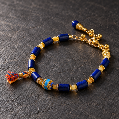 Blue and gold tassel bracelet on dark stone