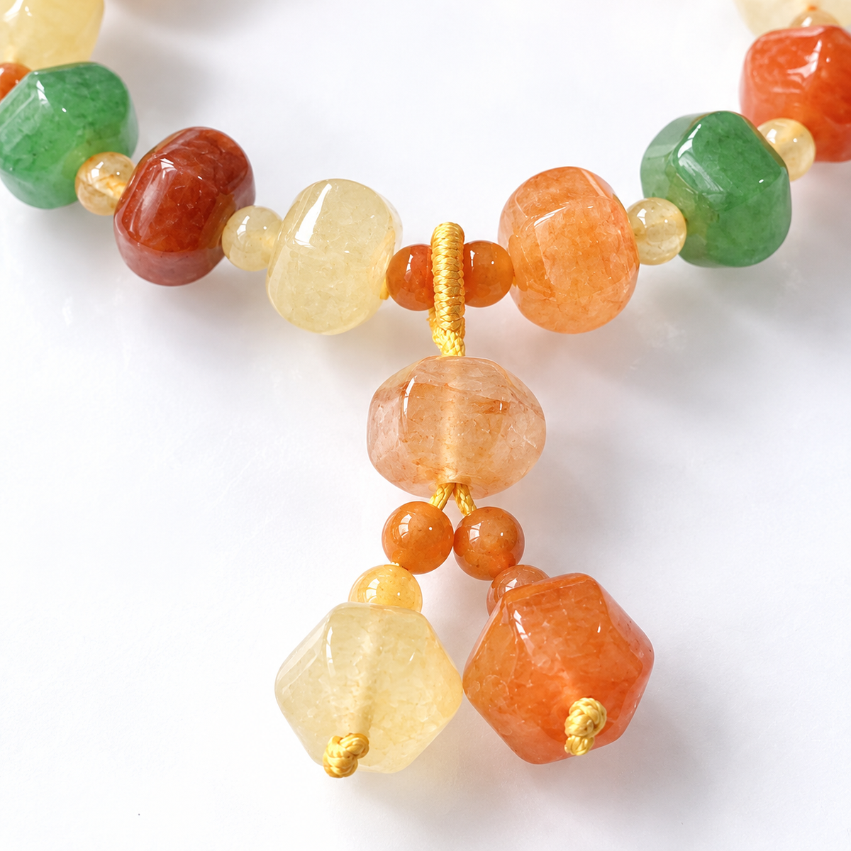 Faceted Golden Silk Jade (Jinsi Yu) multicolor bead bracelet knotted cord and twin bead drop detail