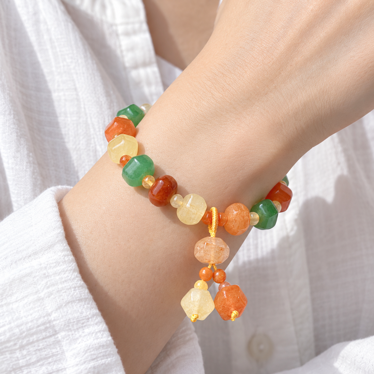 Faceted Golden Silk Jade (Jinsi Yu) multicolor bead bracelet wrist close-up