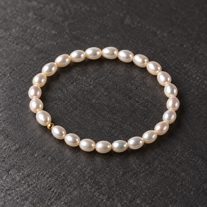 Freshwater teardrop pearl bracelet on a dark textured surface