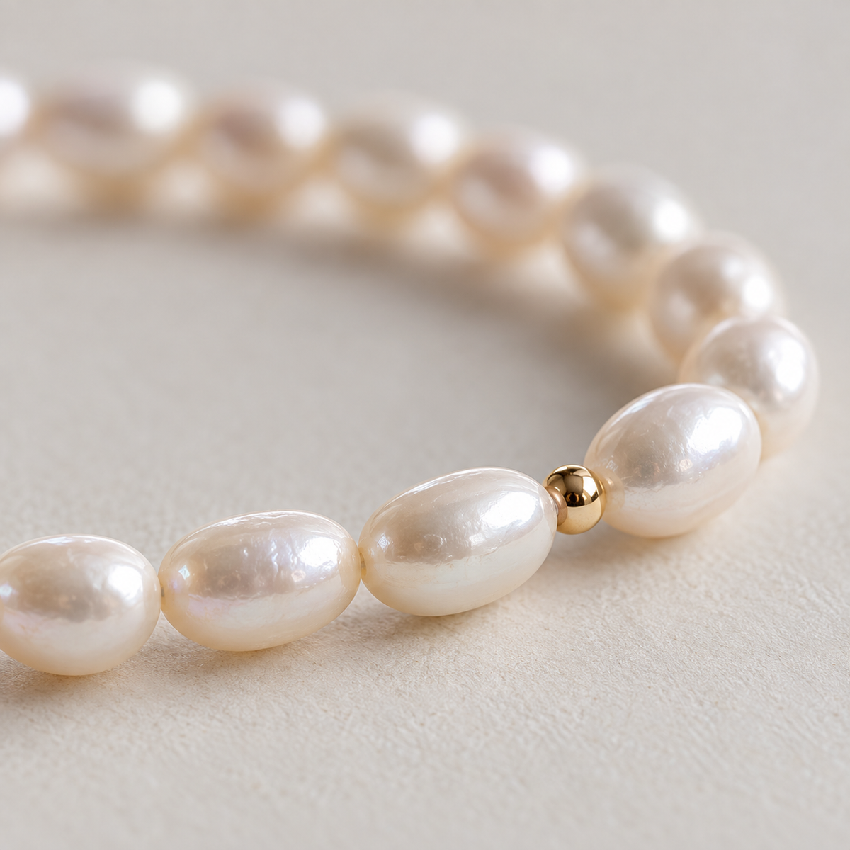 Close-up of teardrop freshwater pearls and gold-tone accent bead