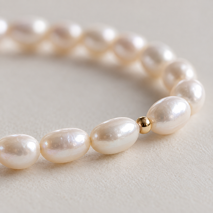 Close-up of teardrop freshwater pearls and gold-tone accent bead