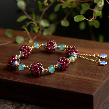 Amazonite garnet cluster bracelet on a wooden surface