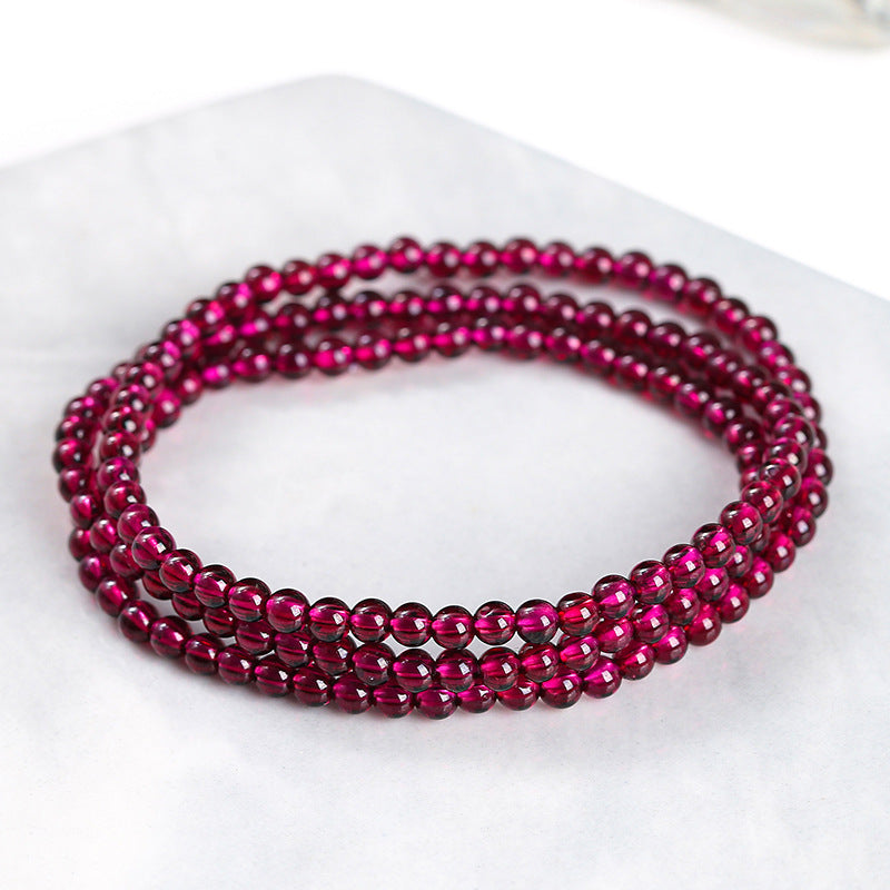Garnet triple-wrap bracelet showing small polished round beads