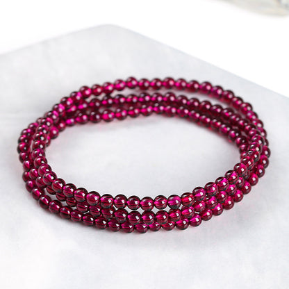 Garnet triple-wrap bracelet showing small polished round beads