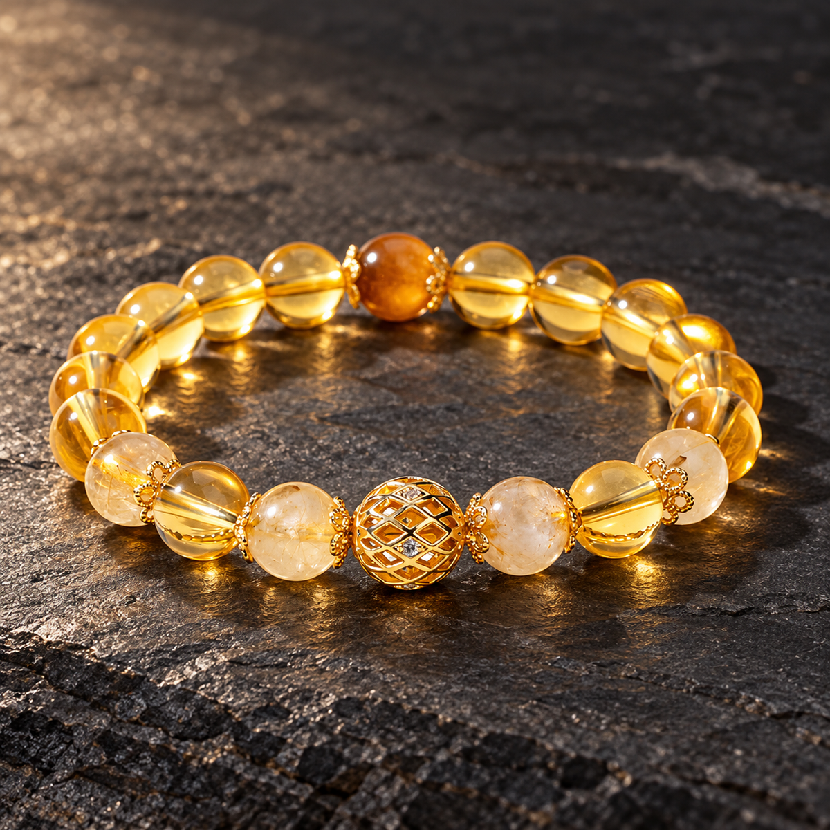 Golden rutilated quartz and citrine bracelet on dark stone