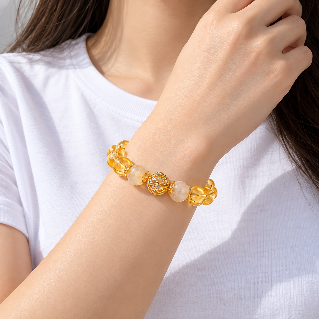 Golden rutilated quartz and citrine bracelet worn with a white shirt