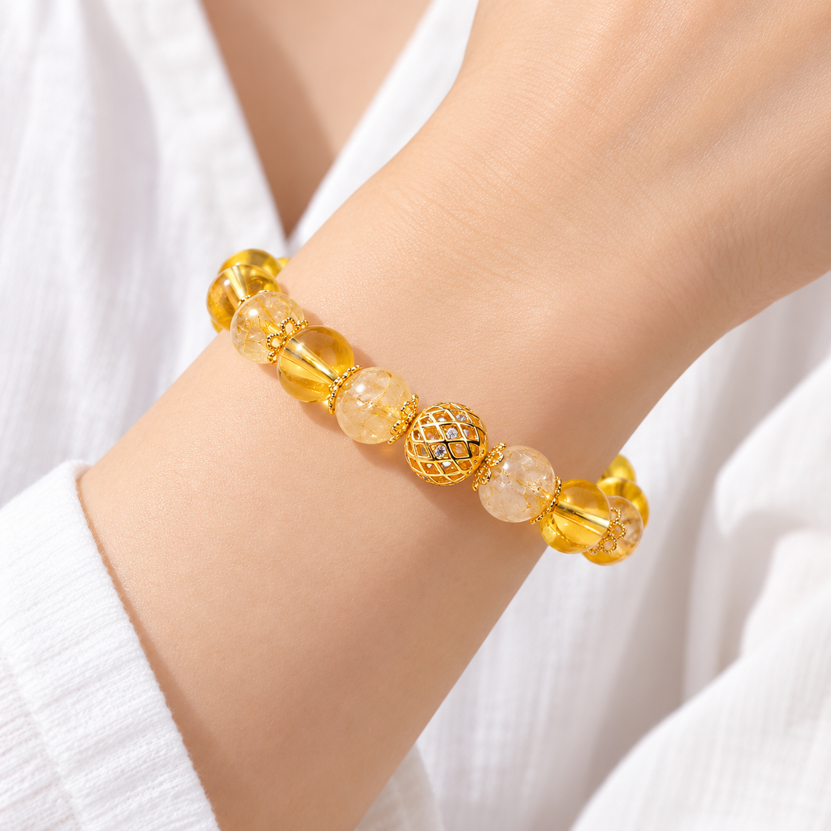 Close wrist view of golden rutilated quartz and citrine bracelet