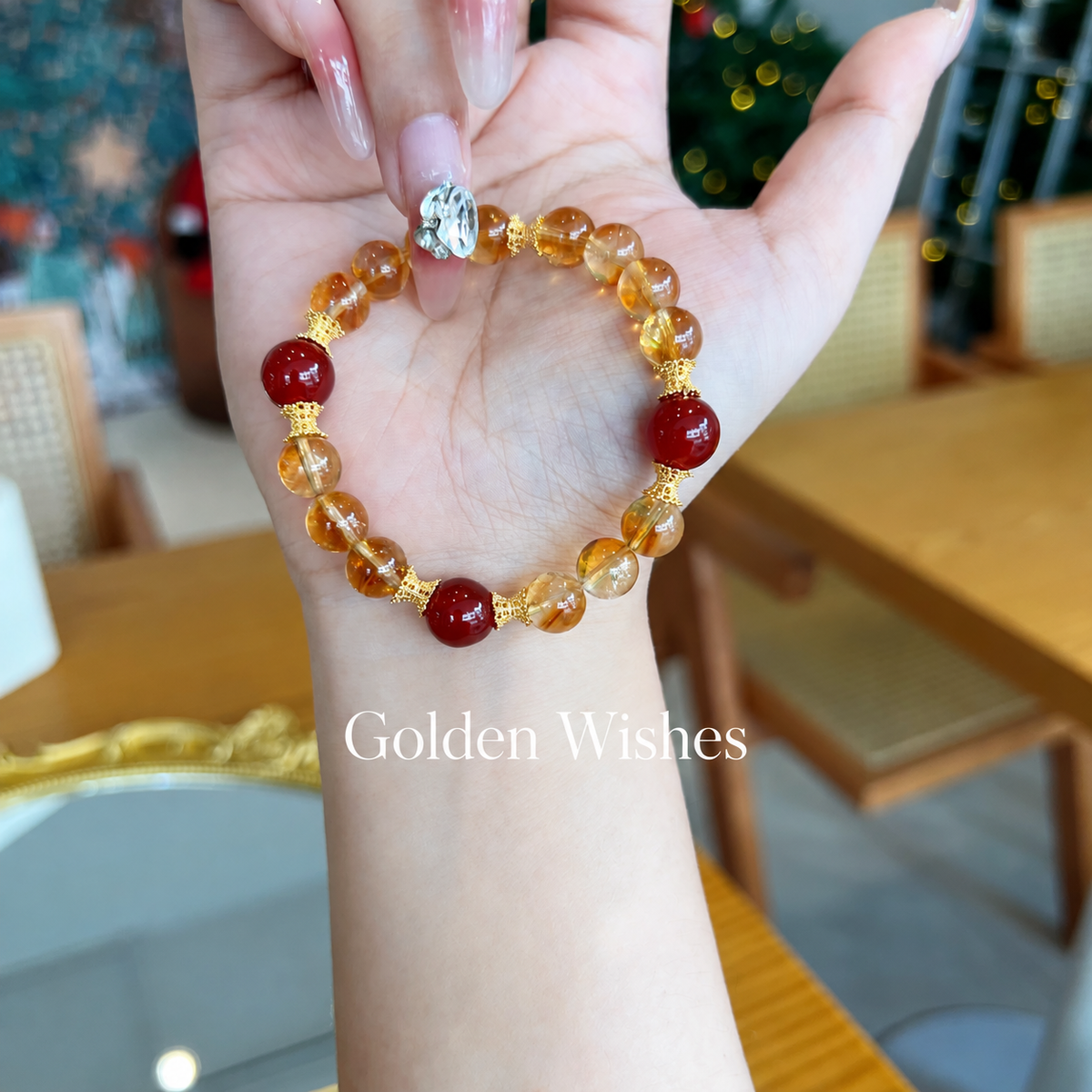 Classic golden quartz and red agate bracelet held in hand
