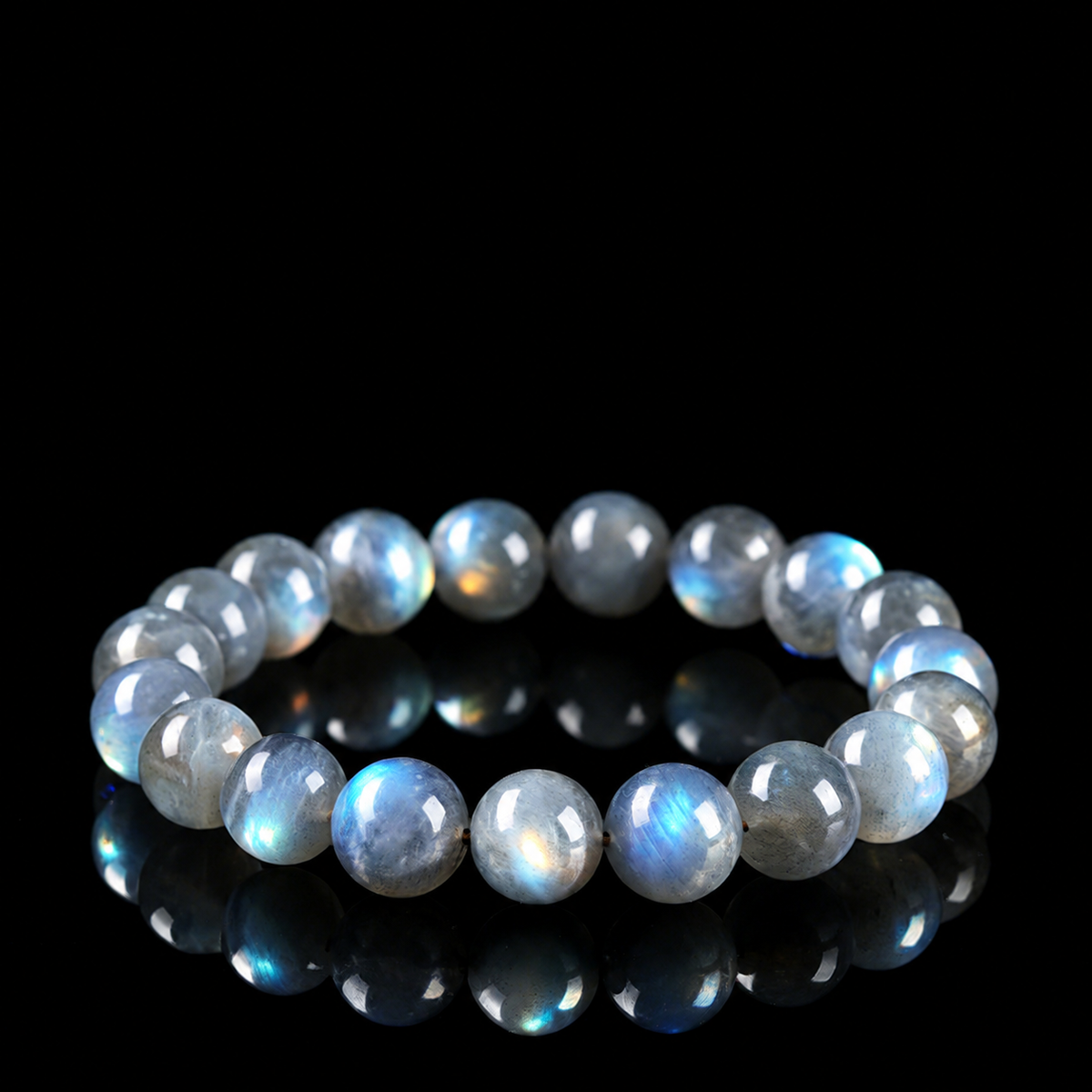 Gray moonstone bracelet with blue optical sheen on black