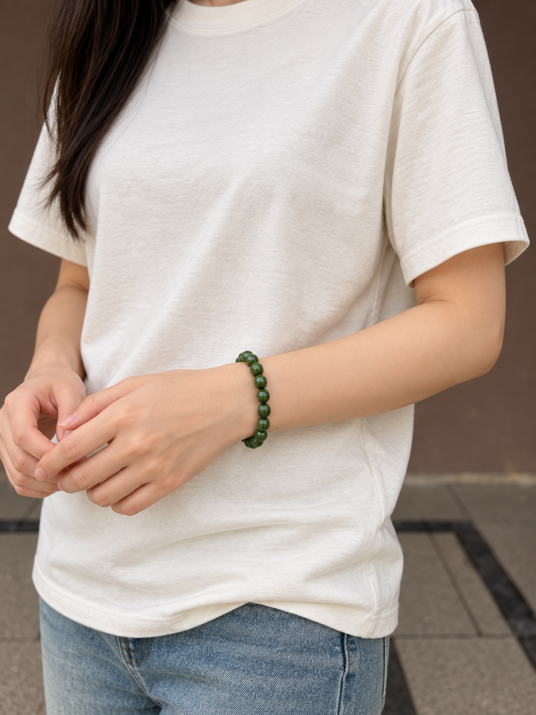 Green wood bead bracelet worn at front wrist view
