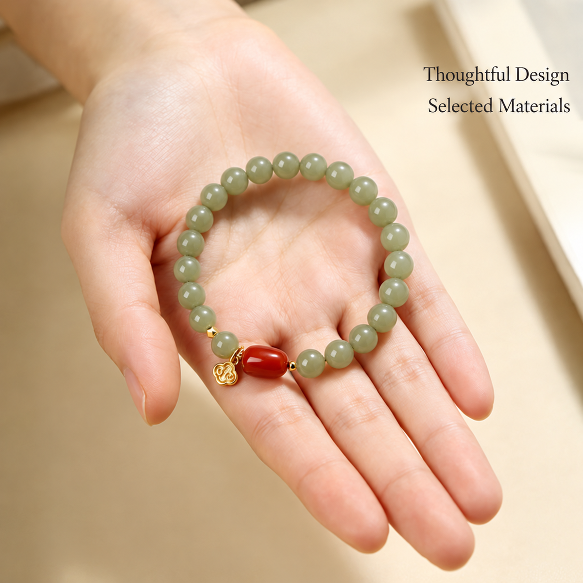 Jade and red agate bracelet shown in a hand