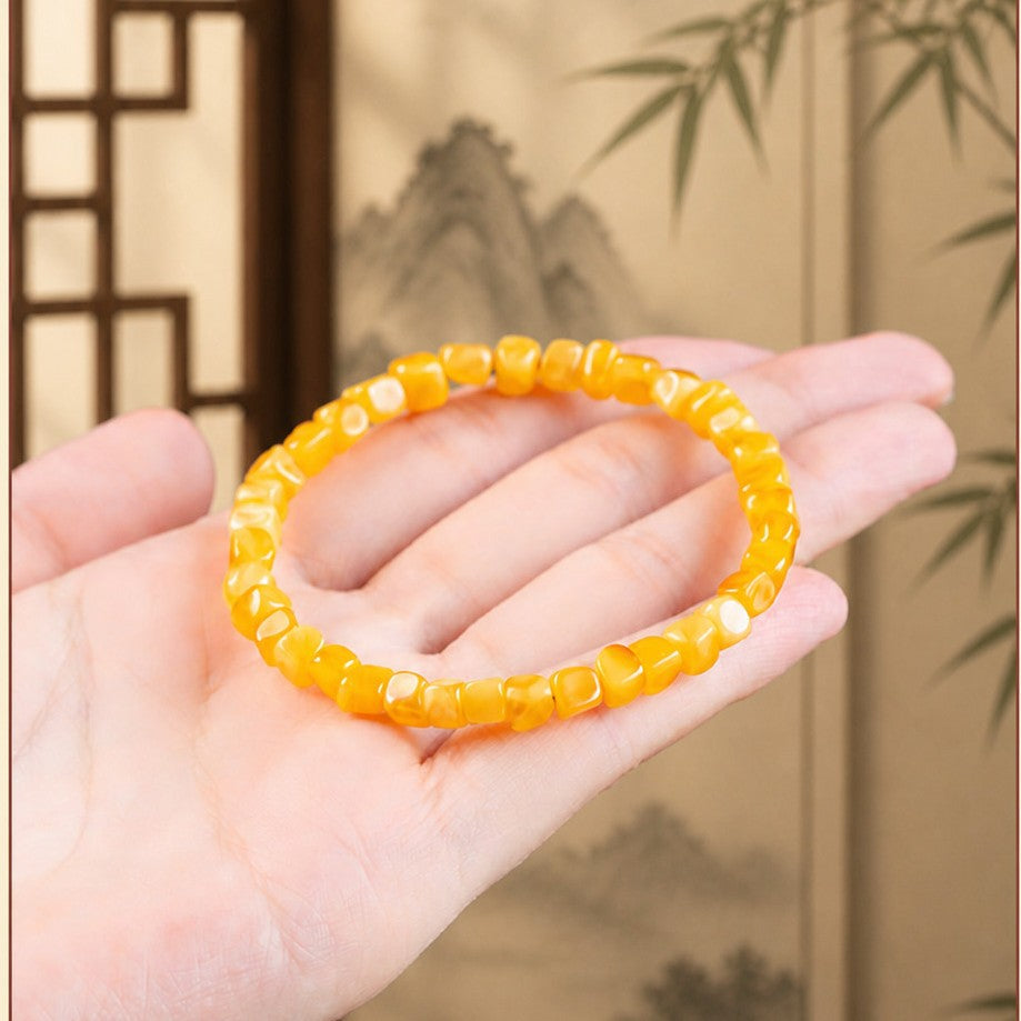 Honey amber bracelet displayed on hand