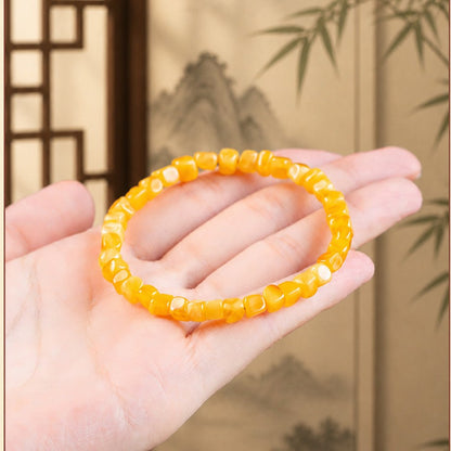 Honey amber bracelet displayed on hand