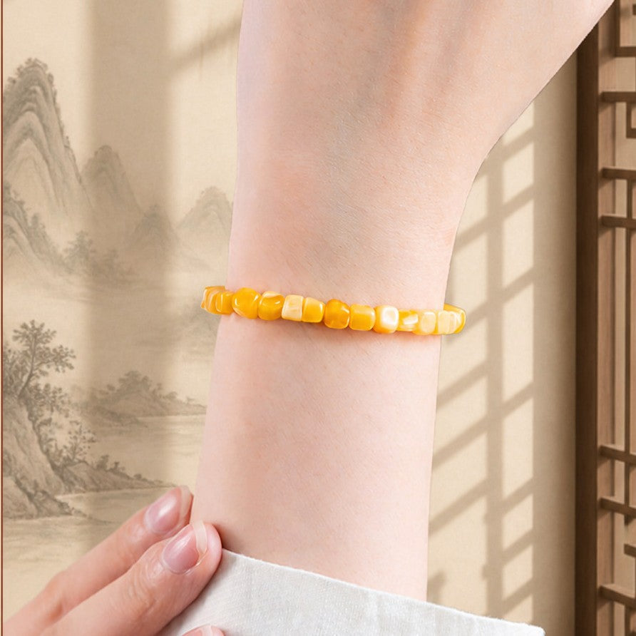 Honey amber rounded-cube bracelet worn on wrist